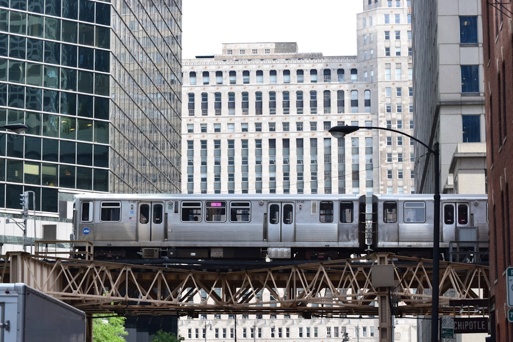 white train on rail near building during daytime