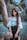 woman in blue denim jacket and blue denim shorts standing beside brown tree trunk during daytime