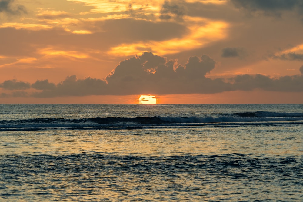 body of water during sunset