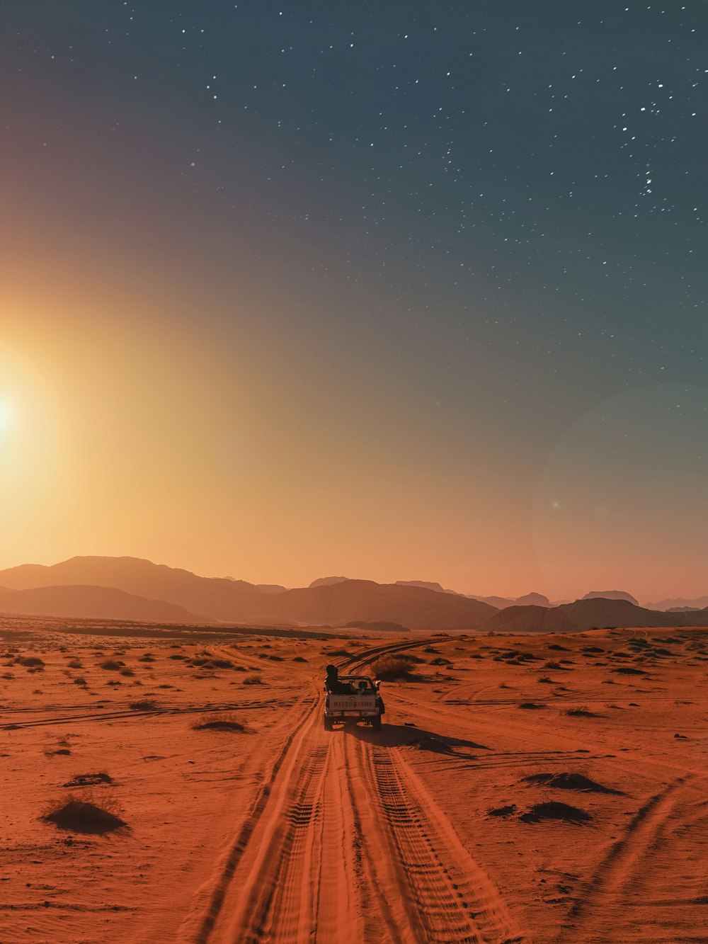 black car on desert during daytime