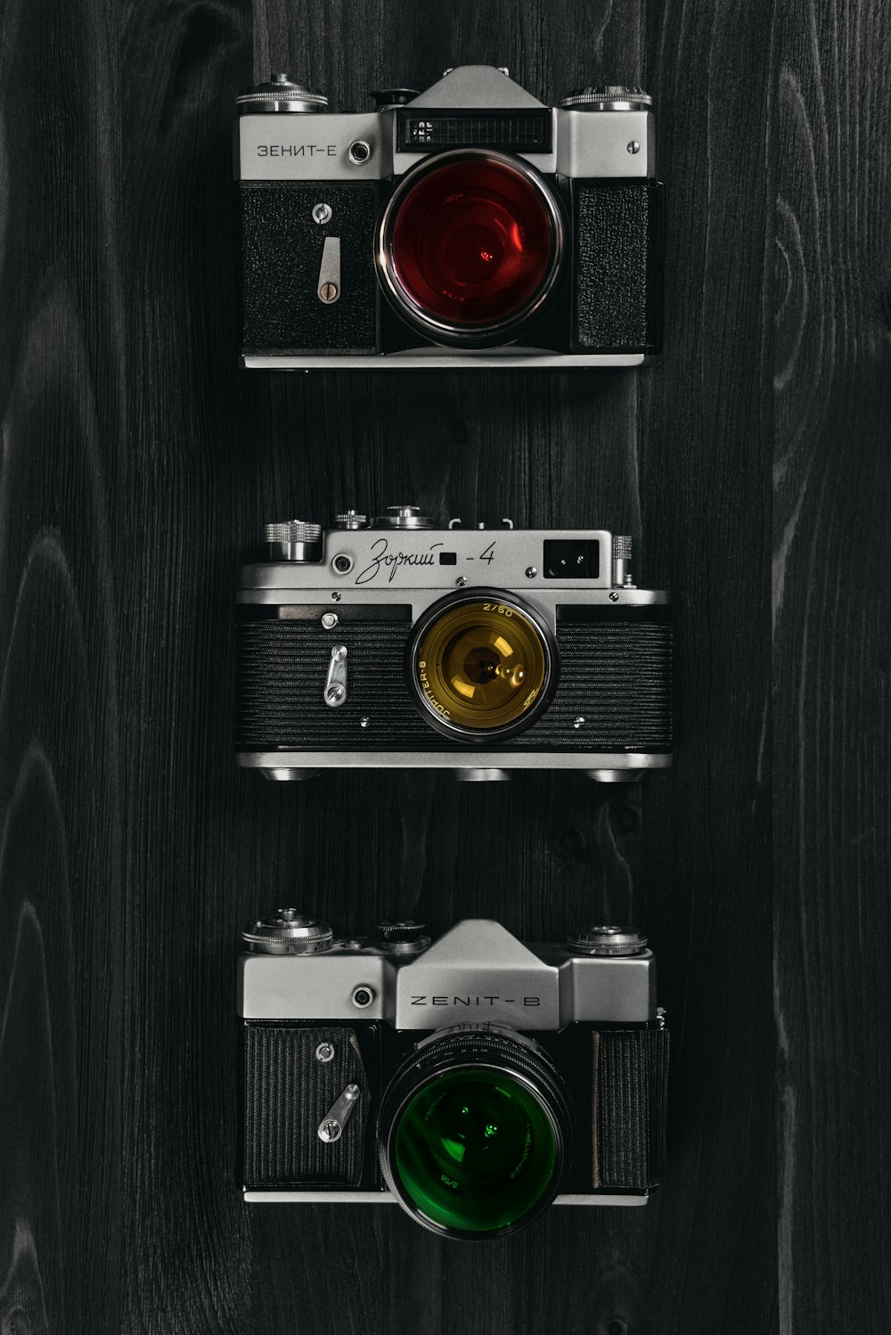 black and silver camera on black wooden table