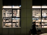 Gustavo Coletti working late at his desk surrounded by books and scripts.