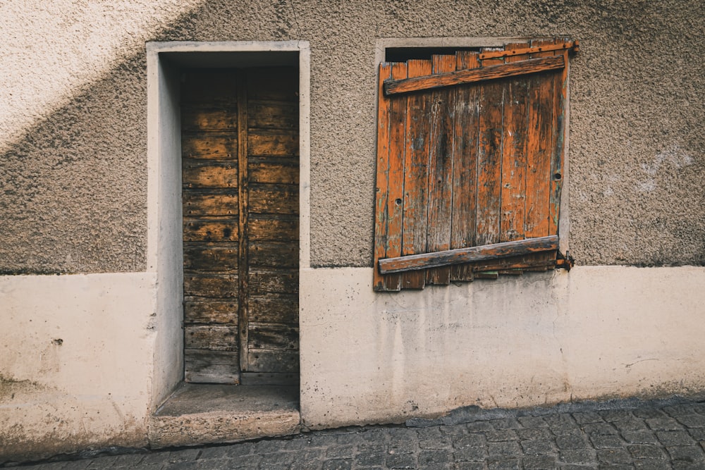 brown wooden window on gray concrete wall