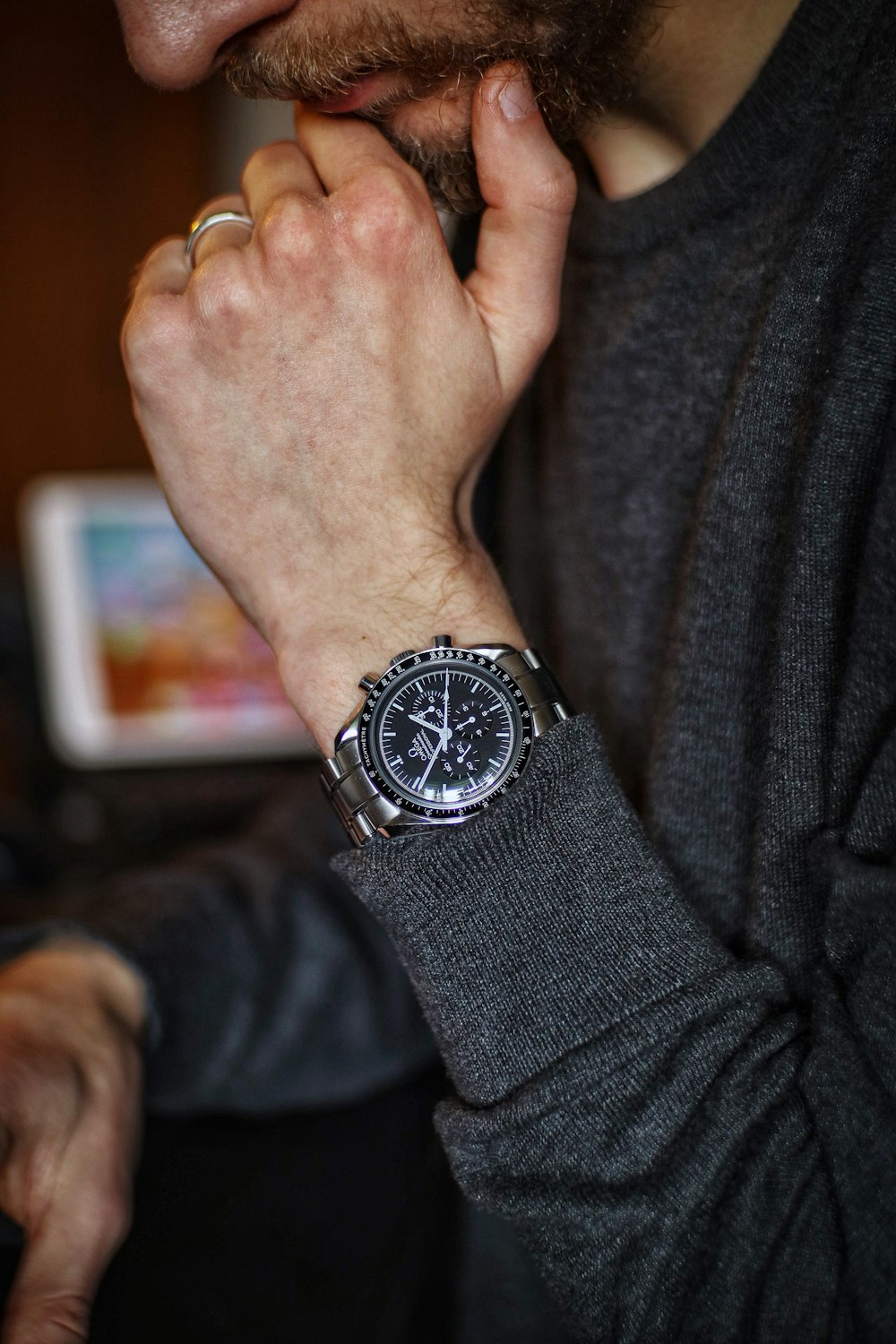 person wearing silver round chronograph watch