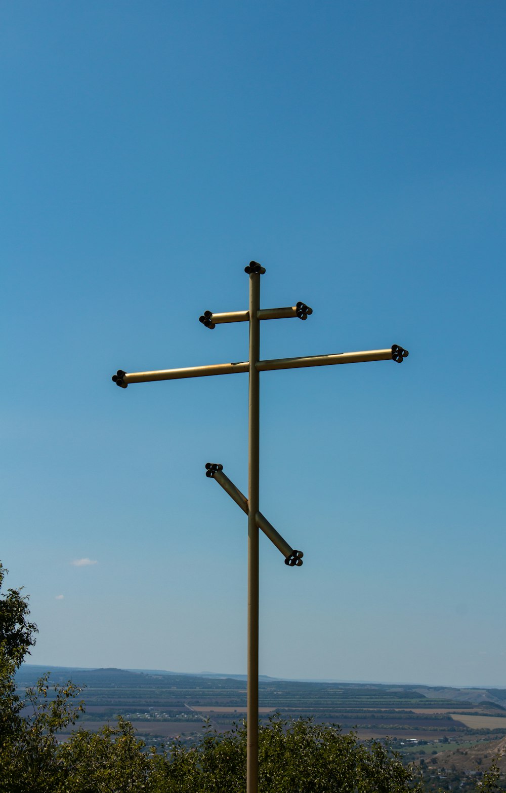 brown wooden cross under blue sky during daytime