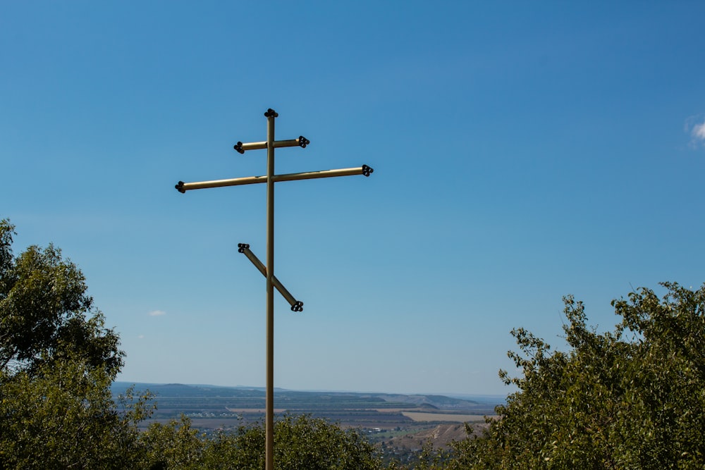 brown wooden cross on green grass field during daytime