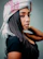woman in black sleeveless top wearing white and pink floral scarf