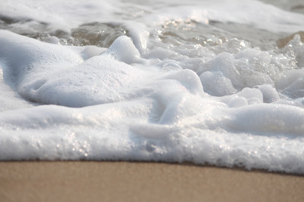 white snow on brown sand