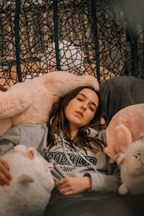 A cozy scene featuring personalized hoodies draped over a chair by a window.