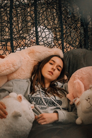 A cozy scene featuring hoodies draped over a modern chair.