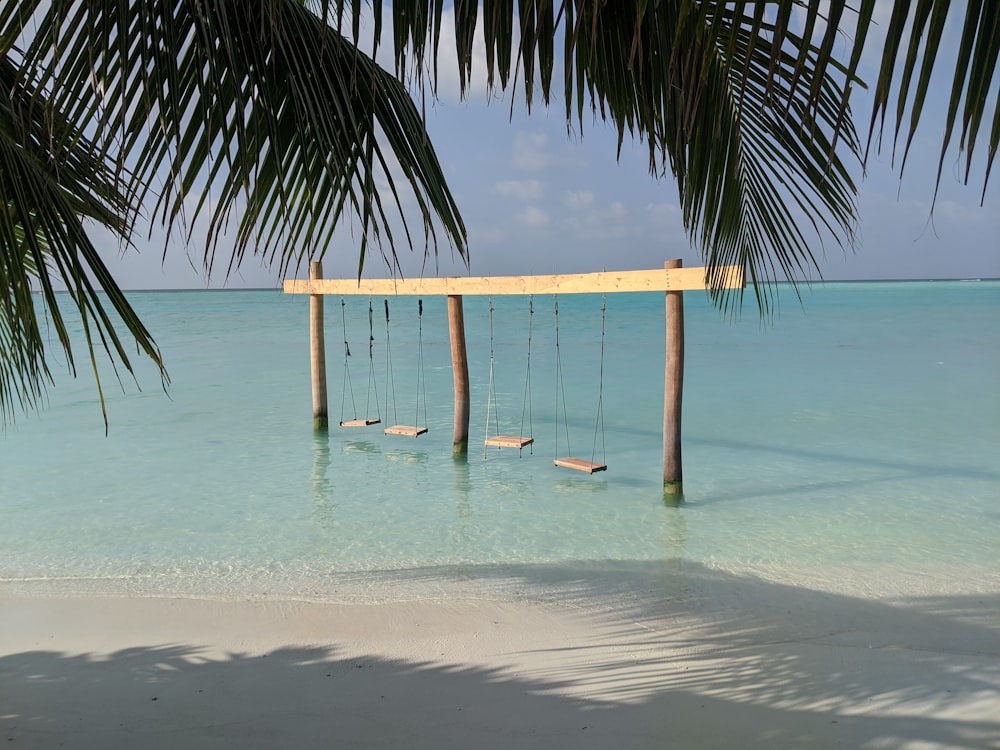 brown wooden beach chair on beach during daytime