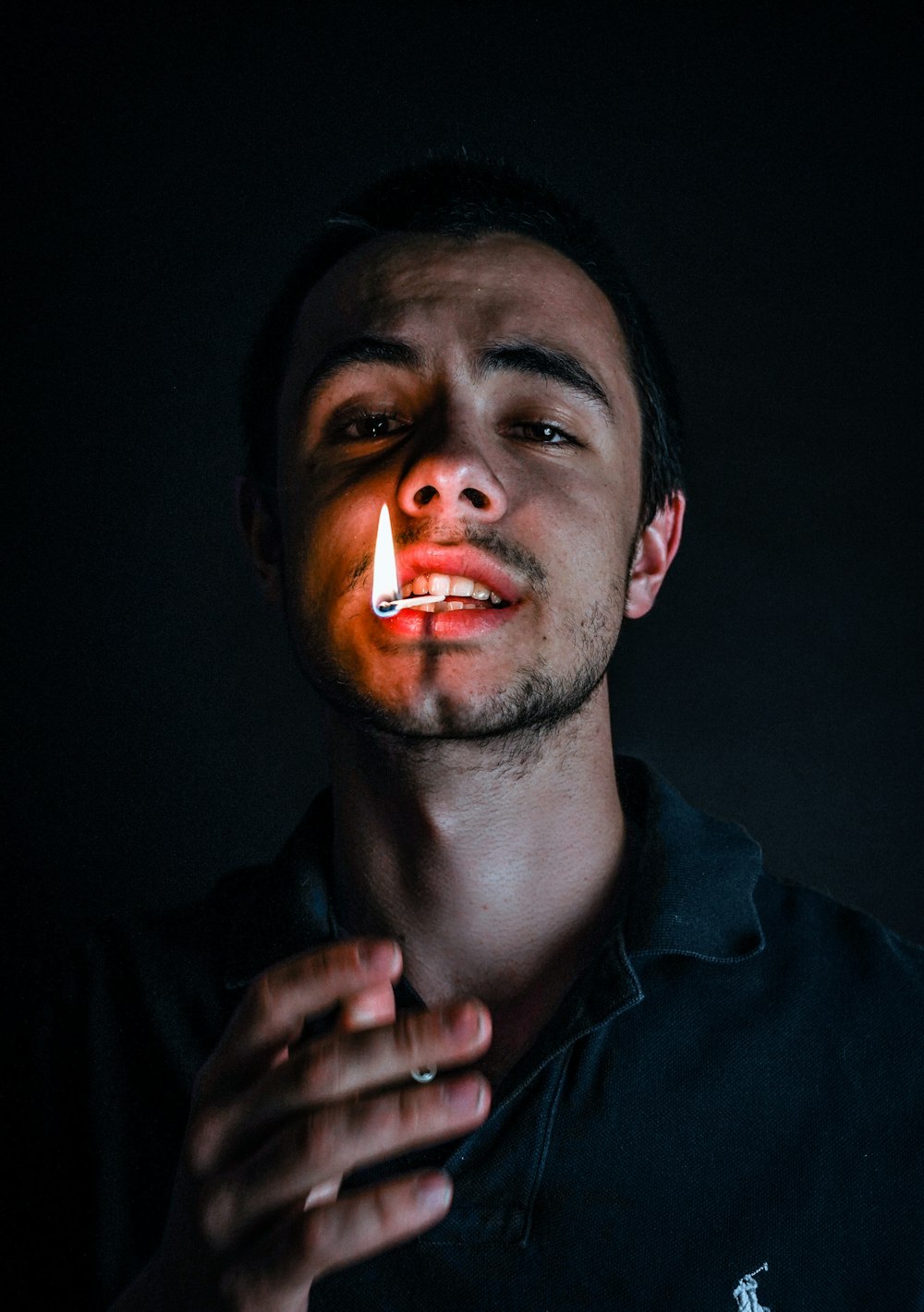 man in black jacket smoking