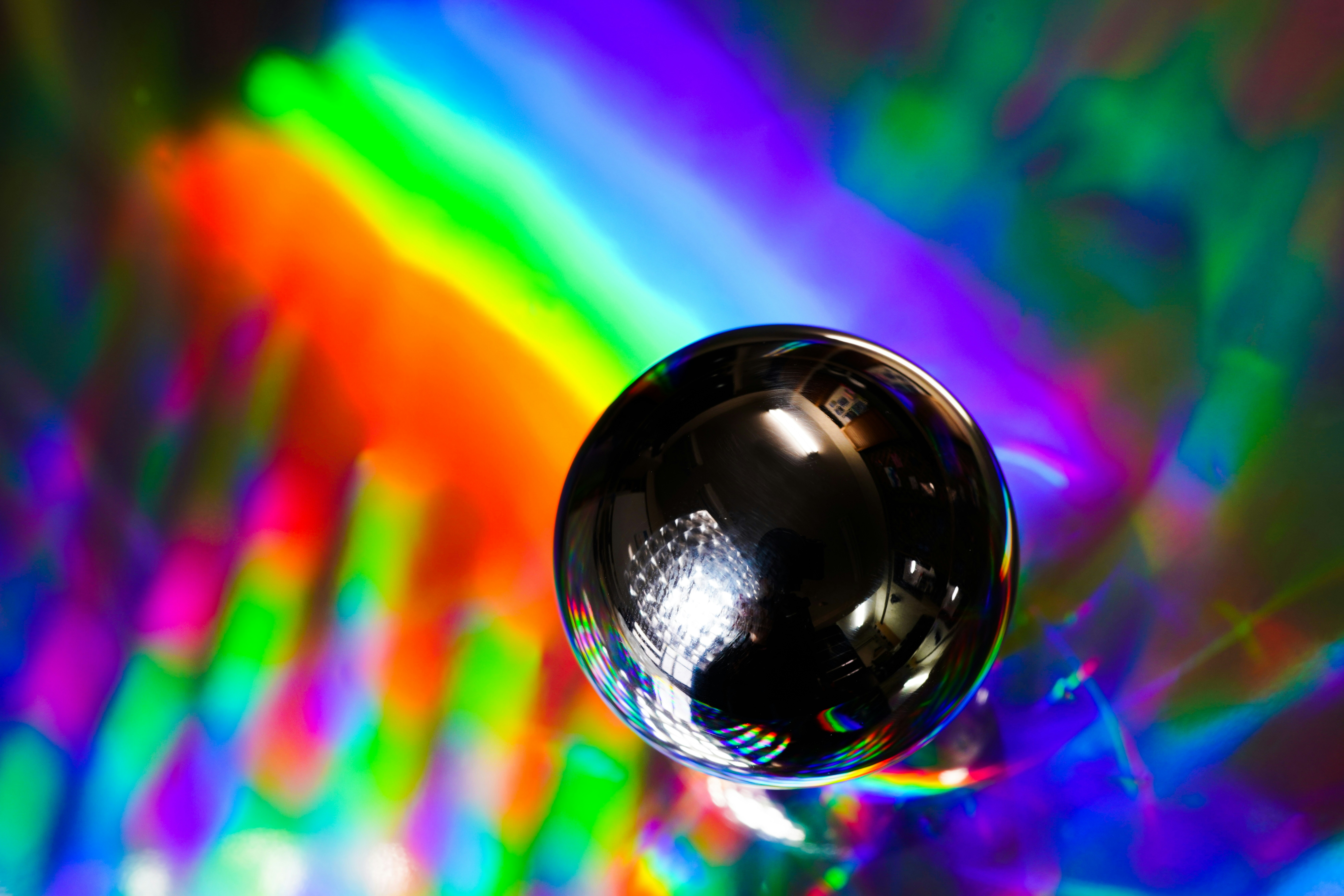 Metal ball on holographic film showing precision manufacturing