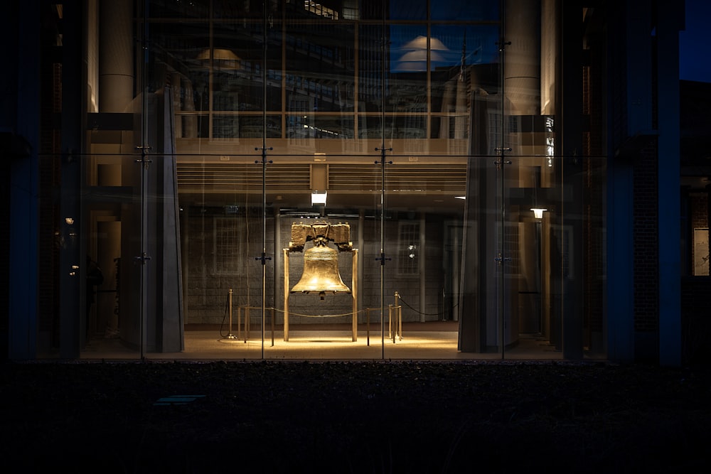 silver and gold bell on black steel fence