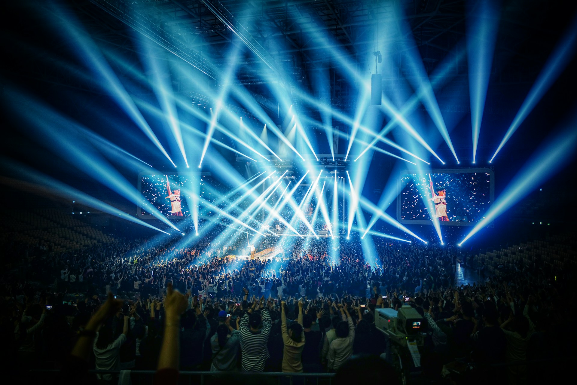 people standing on stage with blue lights