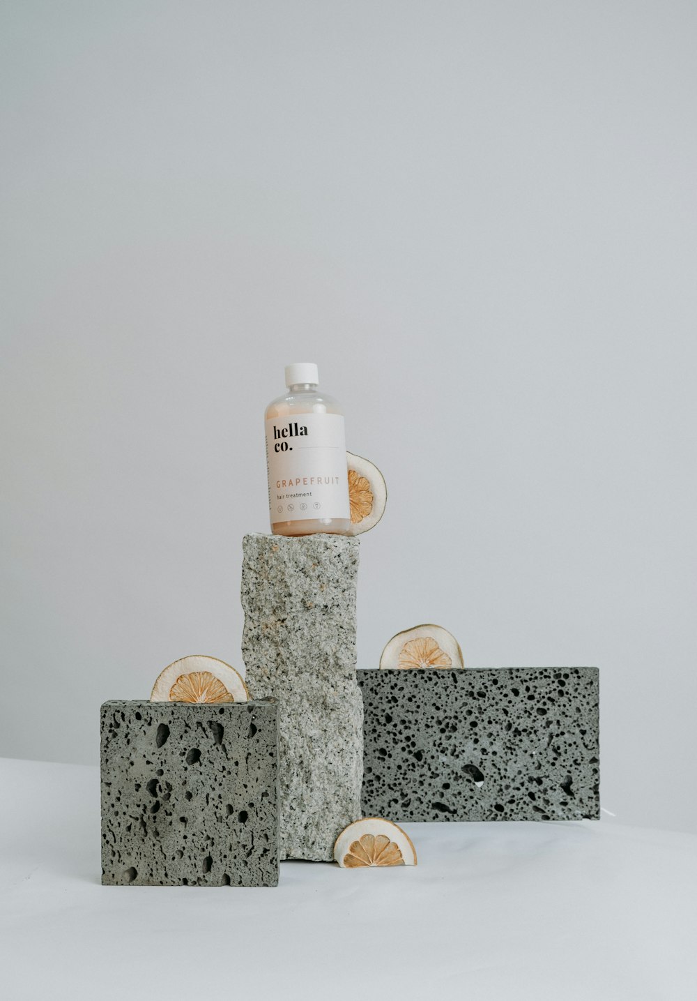 white plastic bottle on brown and gray marble table