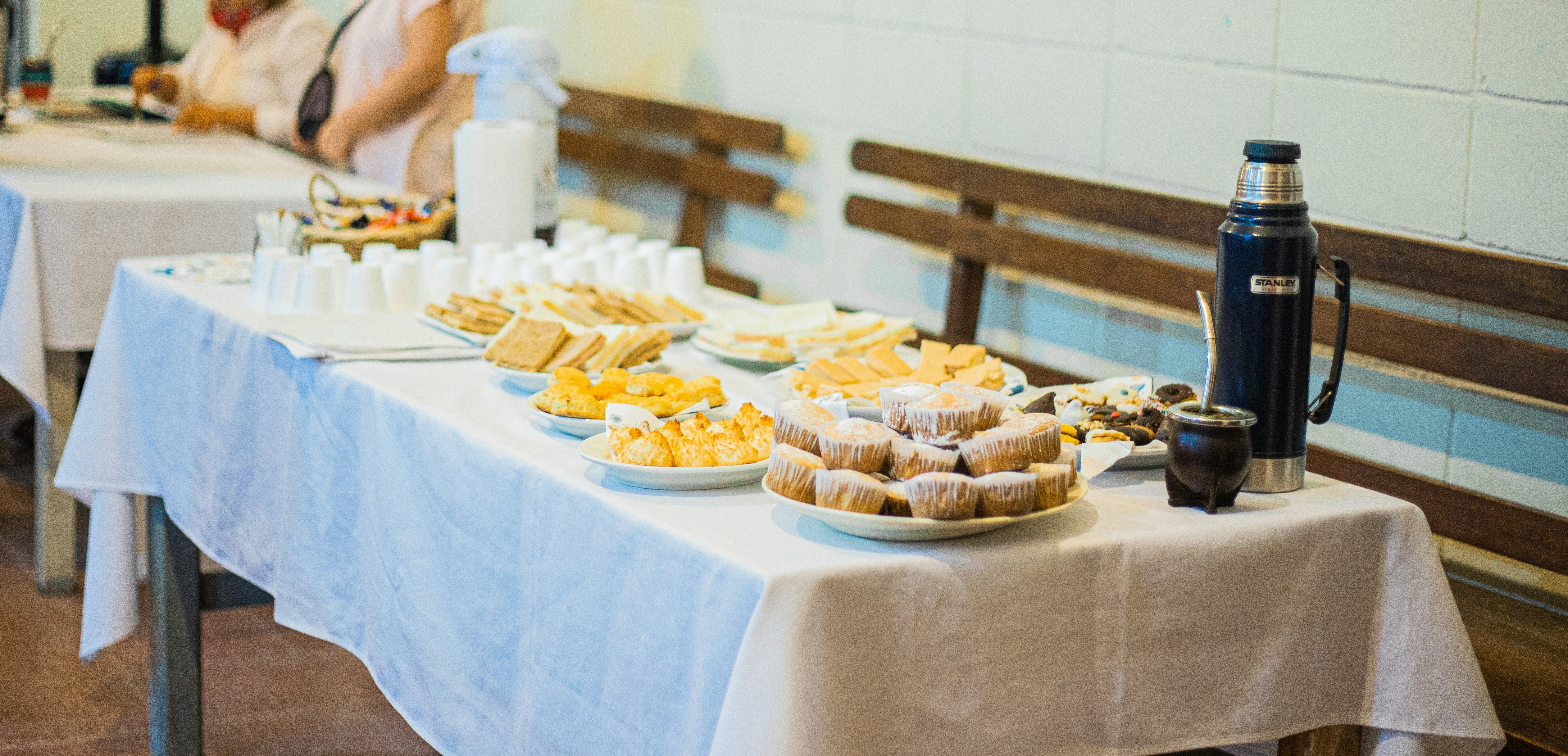 brown and white cupcakes on white table cloth