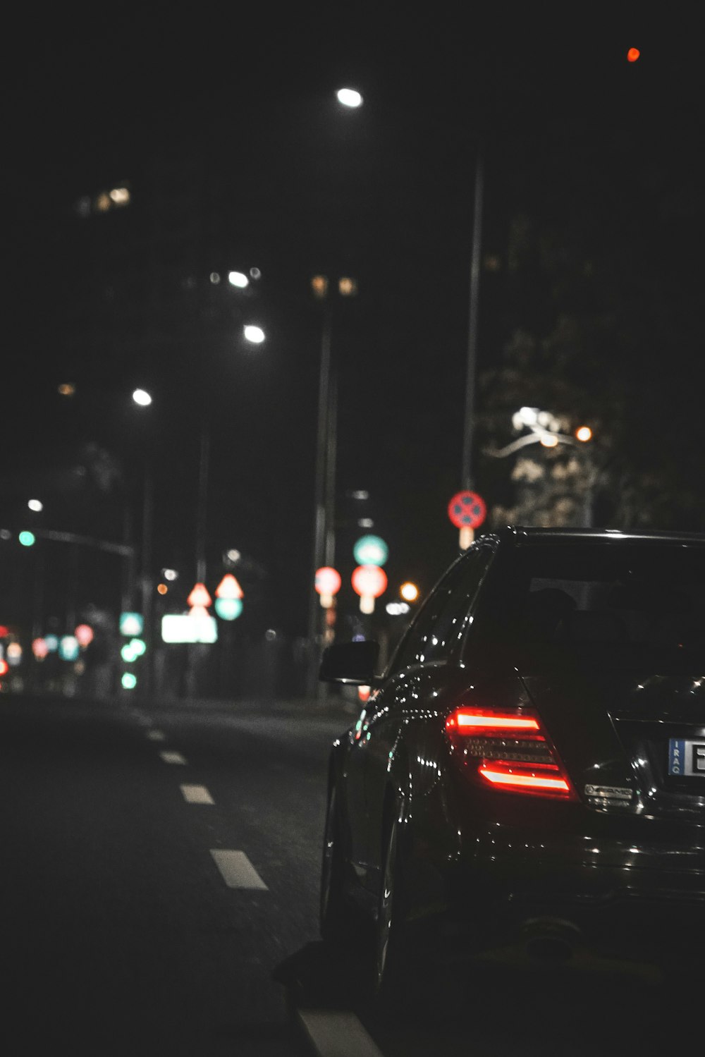 black car on road during night time