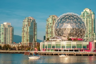 white boat on dock near city buildings during daytime