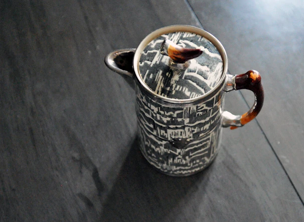 A quirky ceramic teapot shaped like a playful animal with vibrant colors.