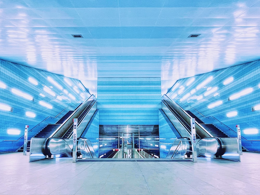 white and black escalator in a building