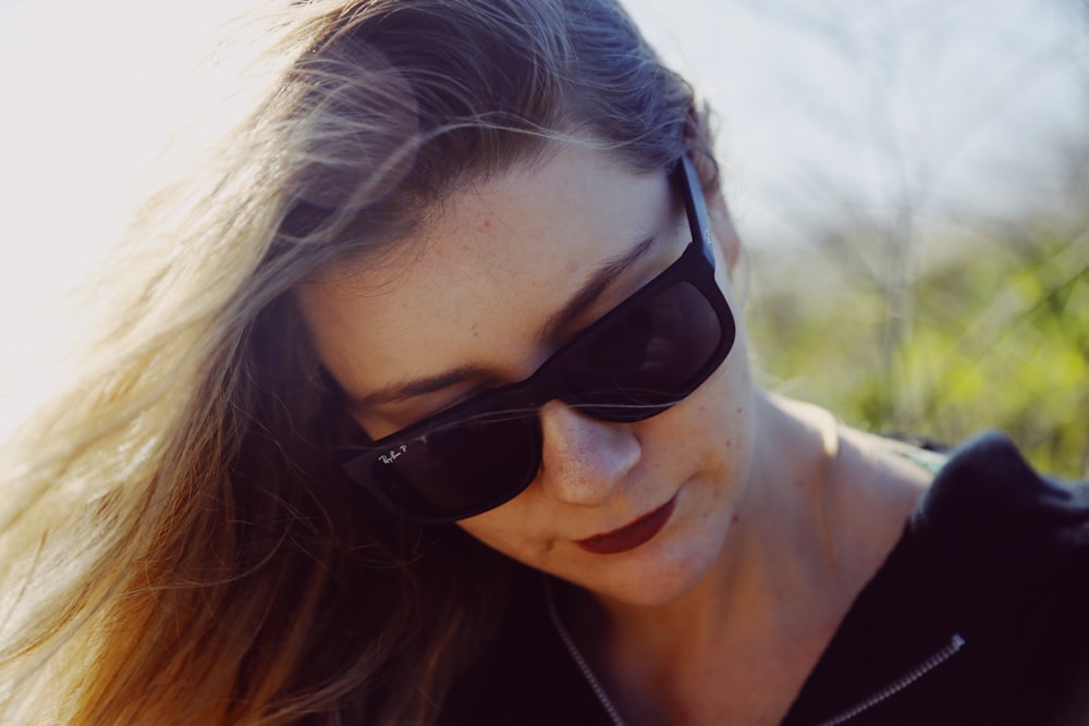 woman in black sunglasses and black shirt