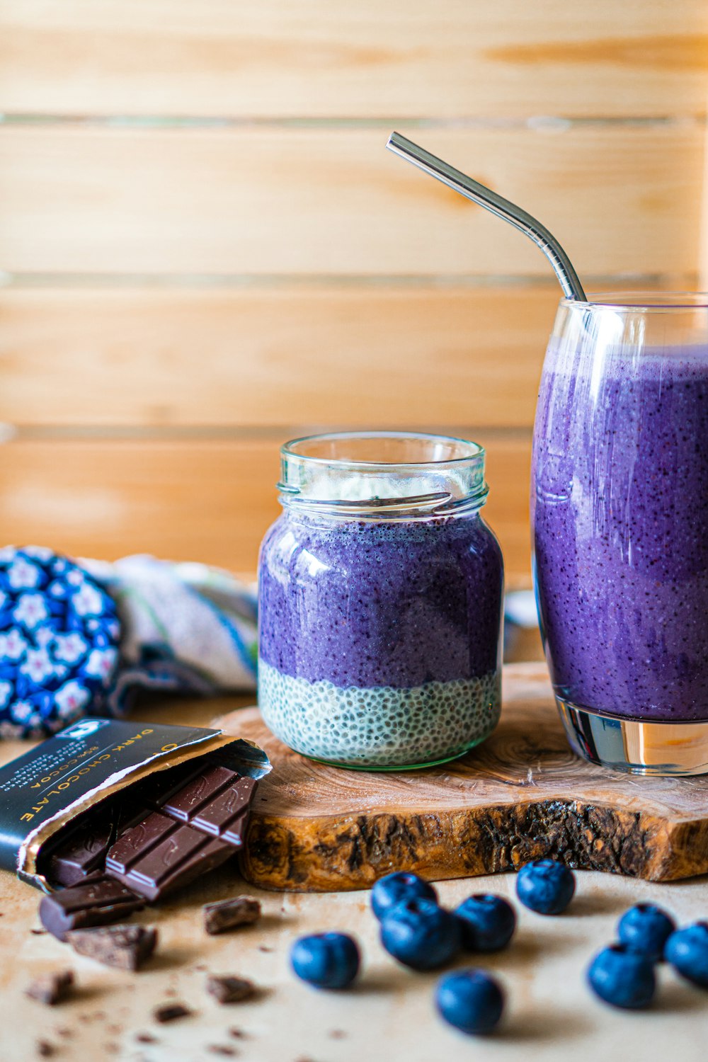 purple liquid in clear glass jar beside black remote control