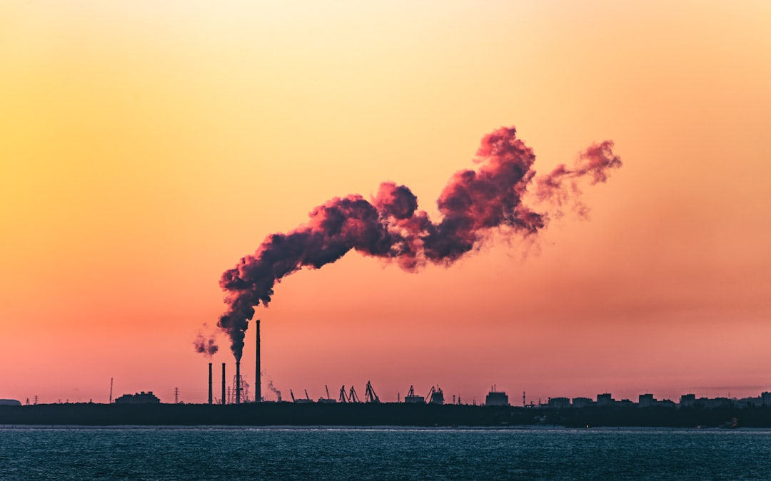  body of water under cloudy sky during sunset chimney