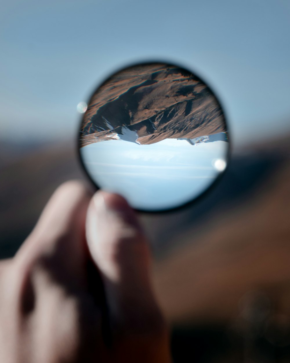 person holding clear glass ball