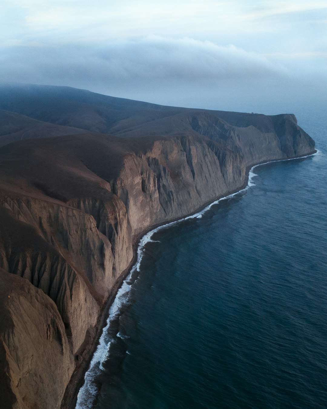 brown rock formation beside blue sea during daytime