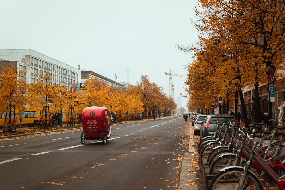 red bus on road during daytime