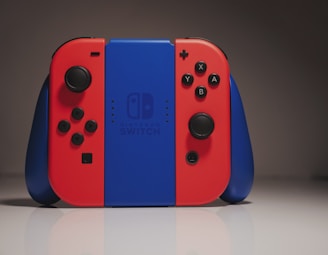 A vibrant Nintendo Switch with detachable Joy-Cons displayed on a wooden table.