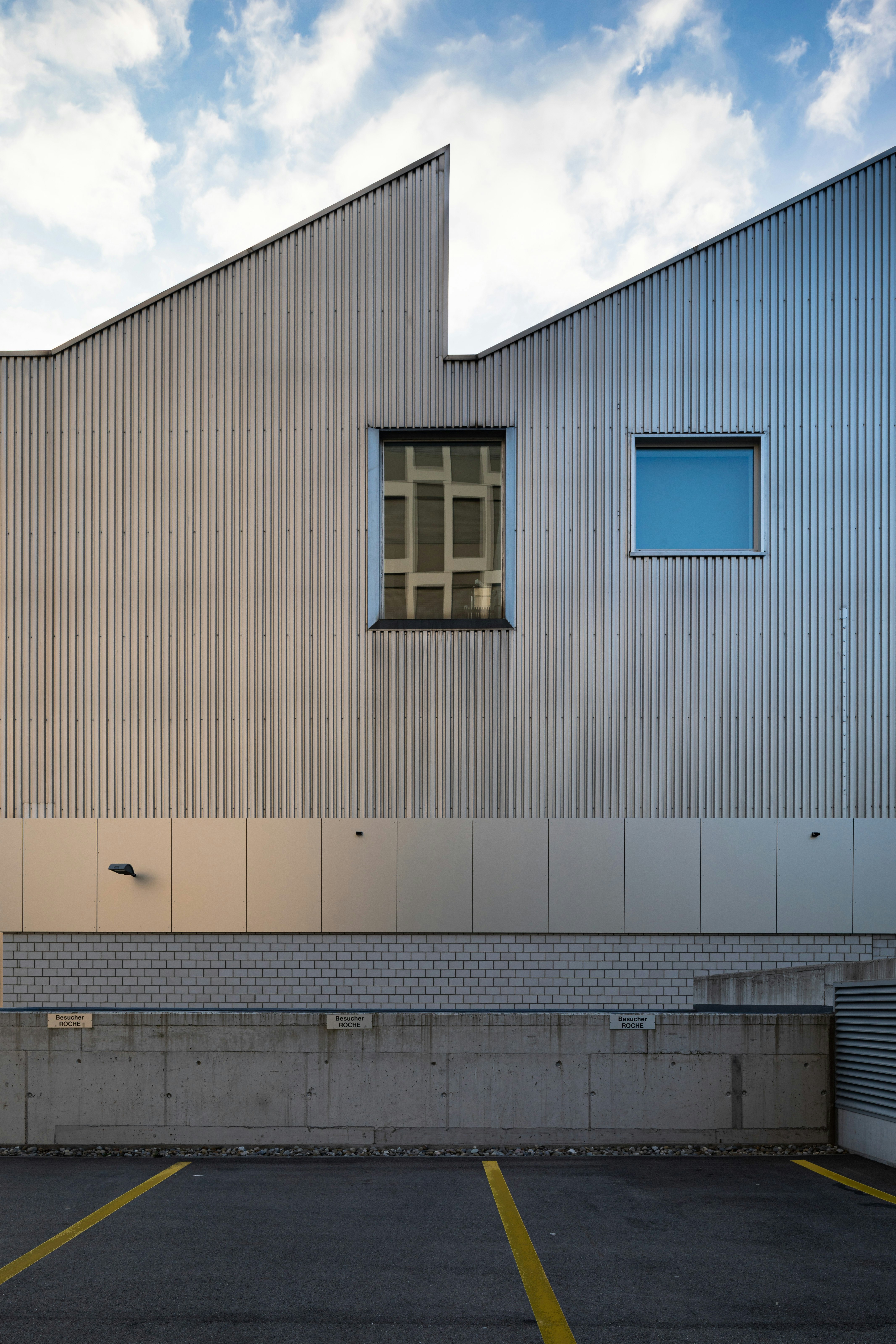 white and blue concrete building under white clouds during daytime