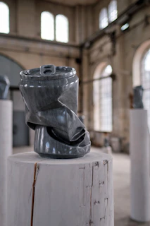 An elegant sculpture made of recycled materials, showcased on a pedestal.