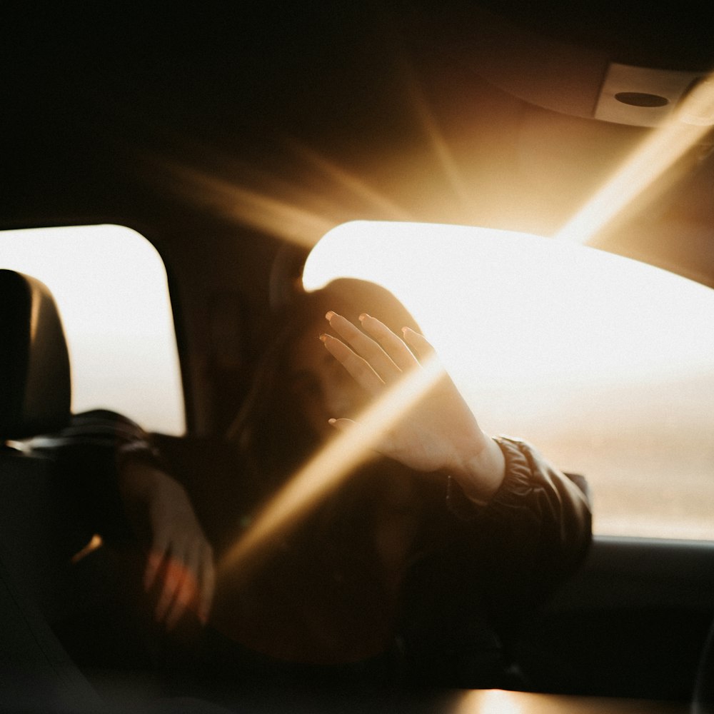 person in black jacket driving car