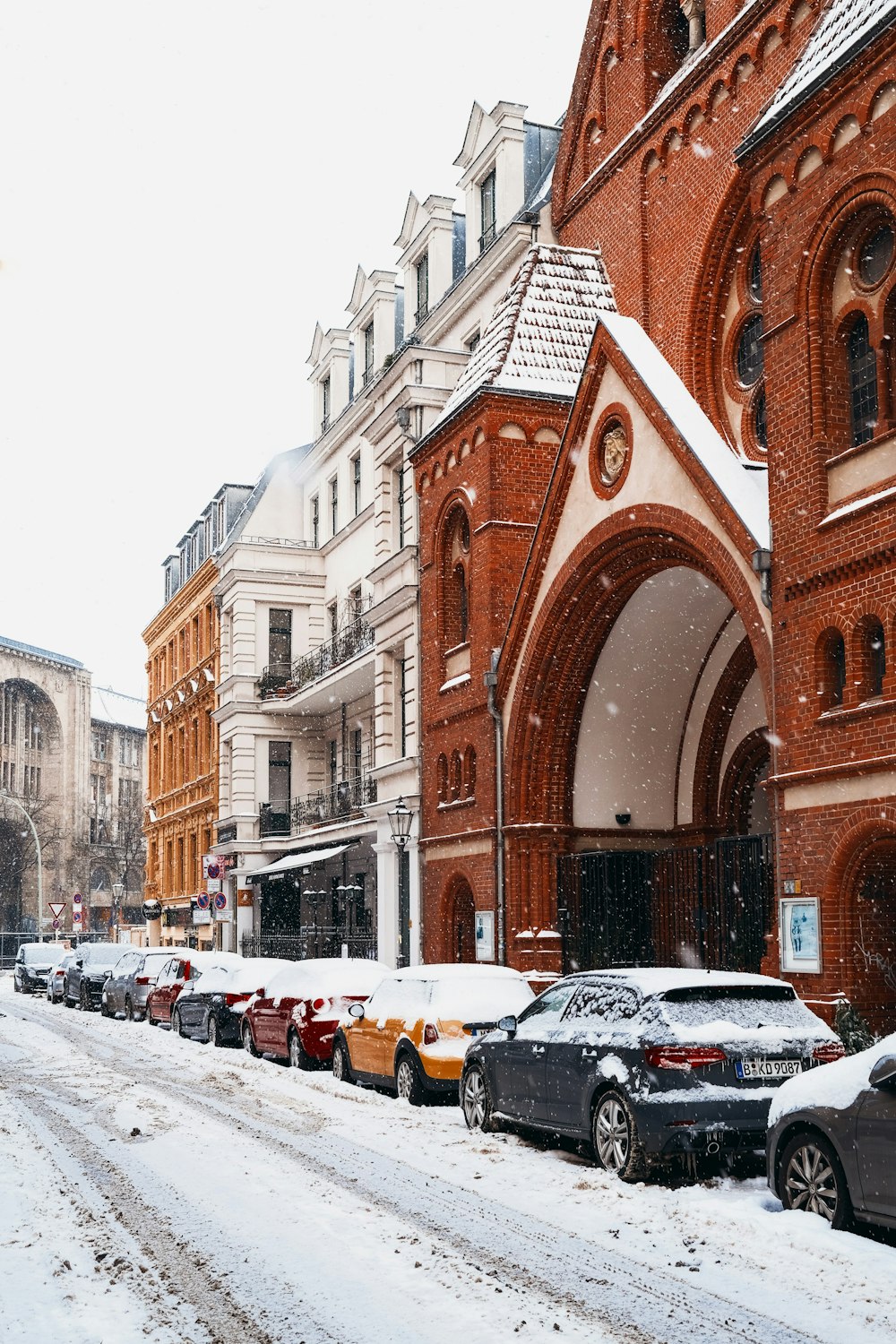 cars parked in front of brown building during daytime