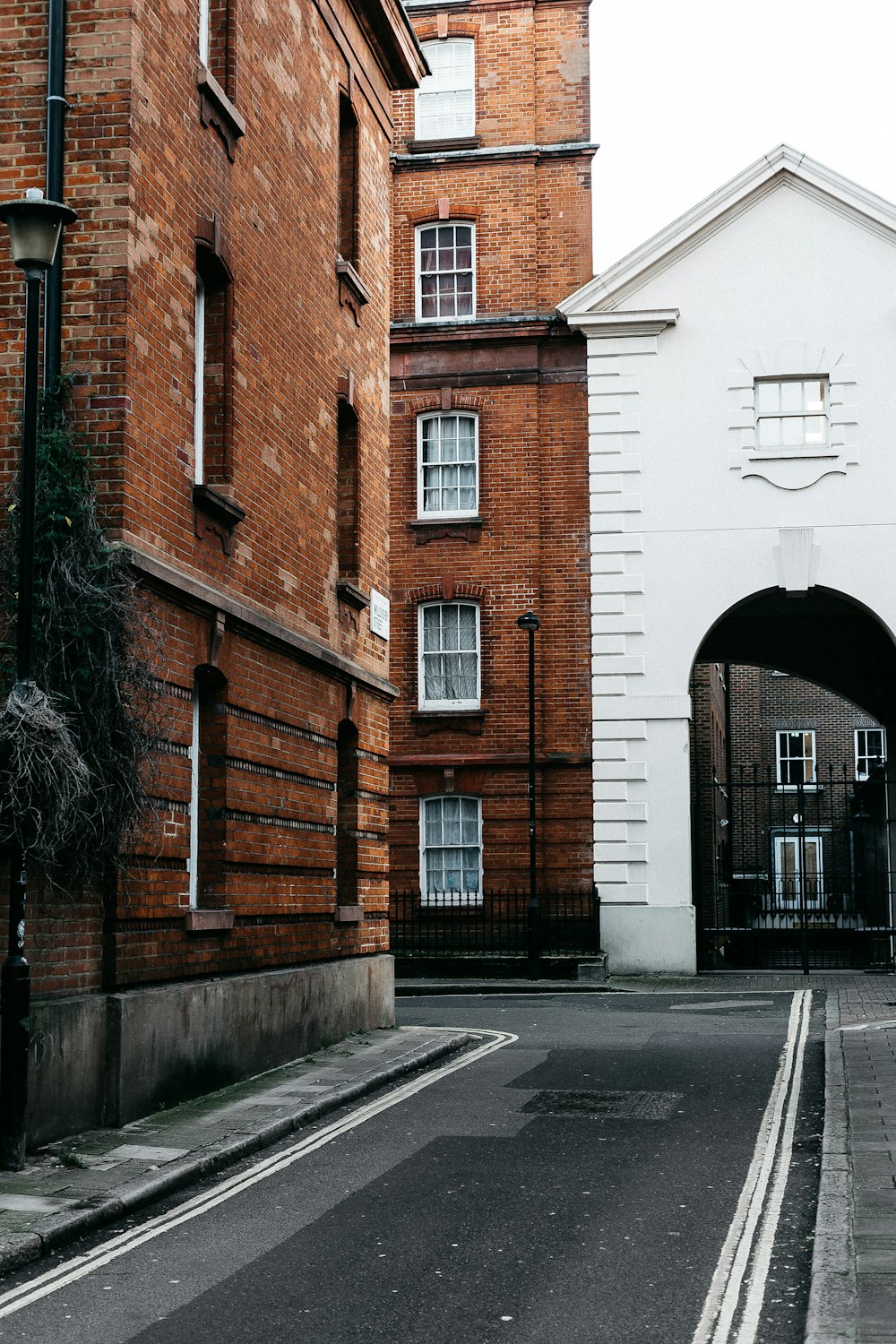 brown brick building beside road during daytime