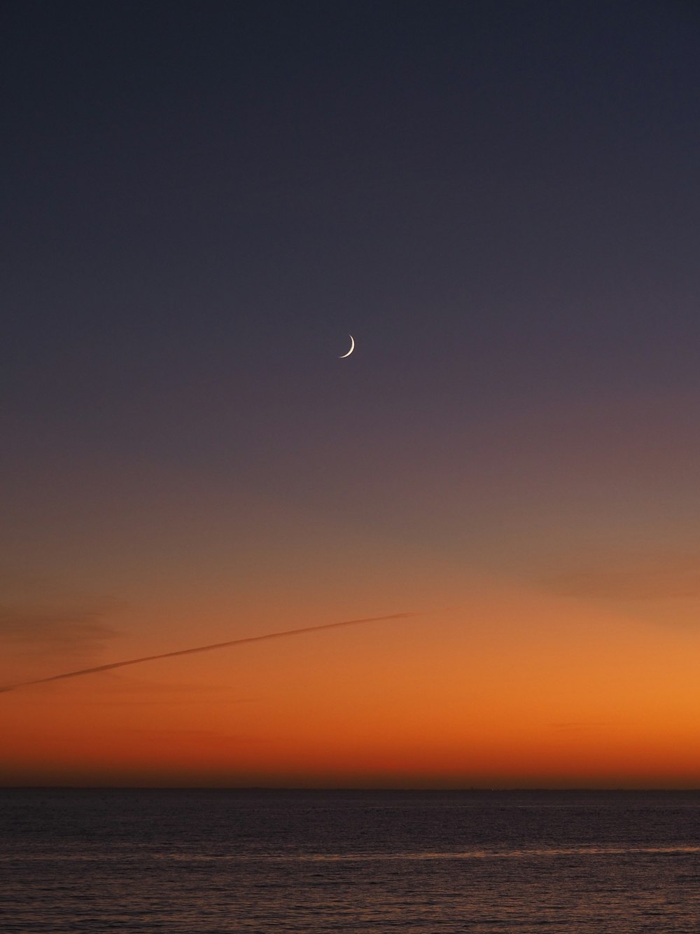 airplane flying over the sky during sunset