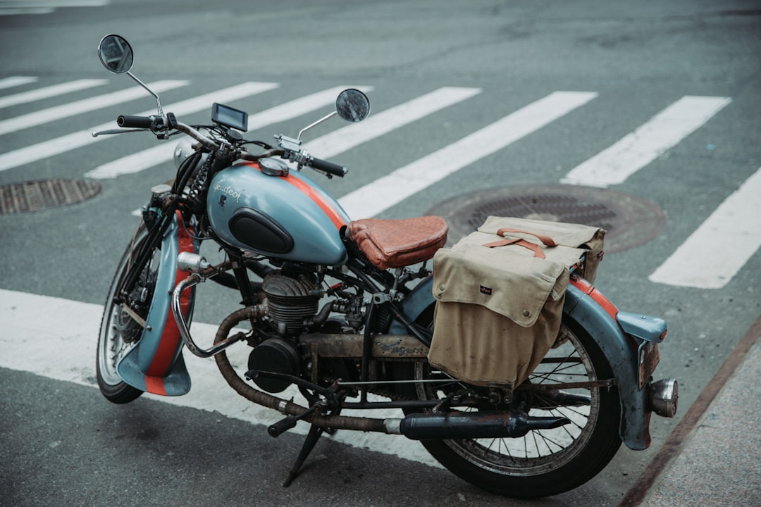 black motorcycle with brown leather bag on top