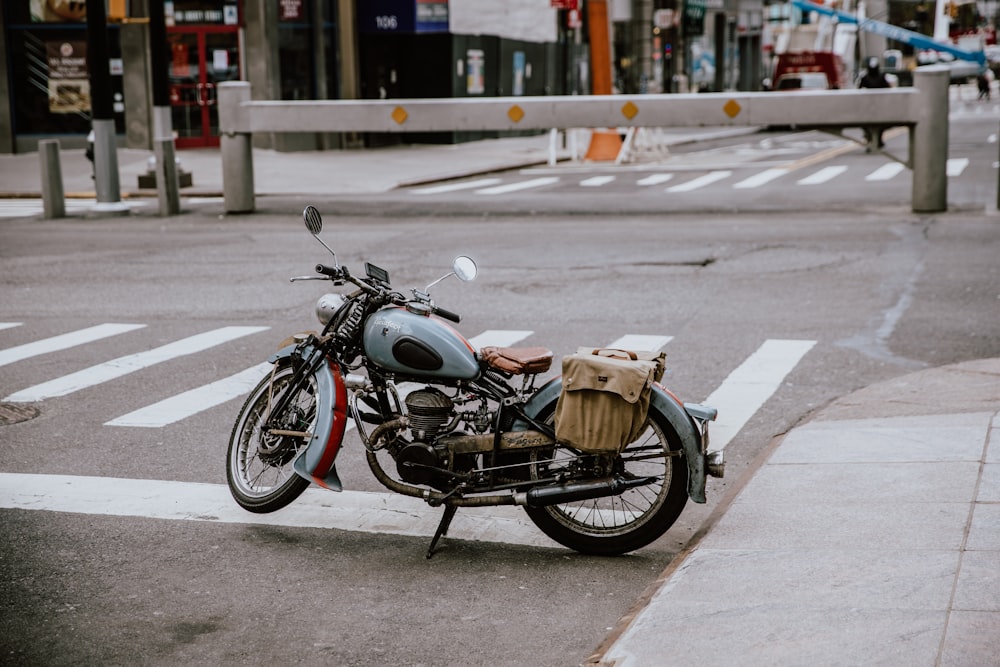 black motorcycle with brown cardboard box on top