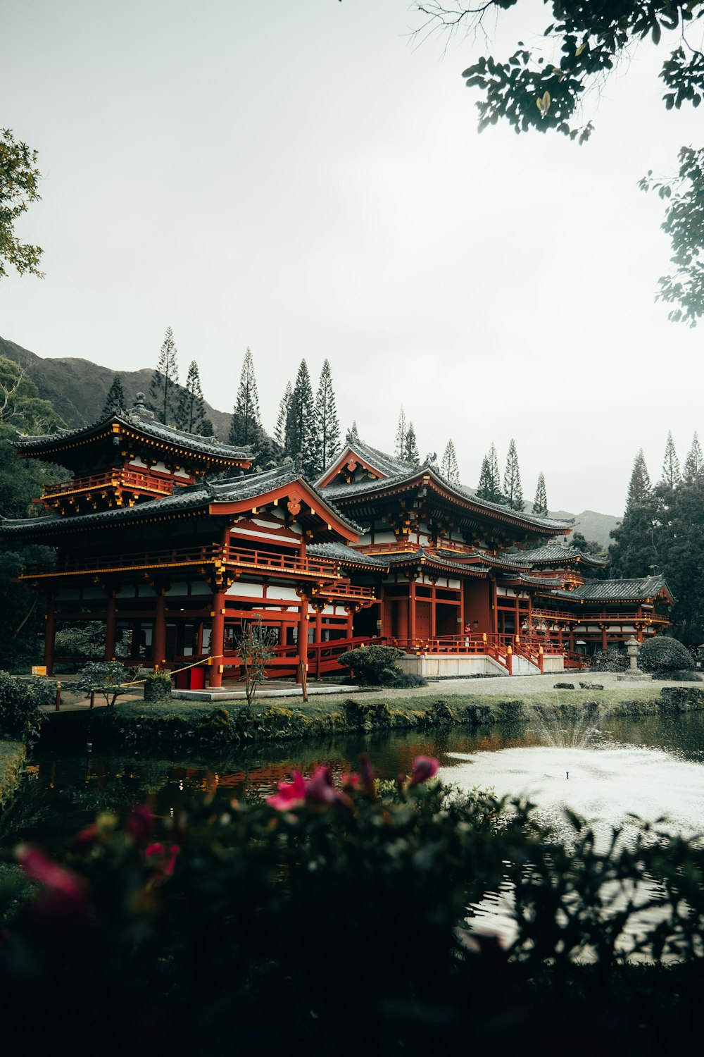 red and brown temple surrounded by trees during daytime