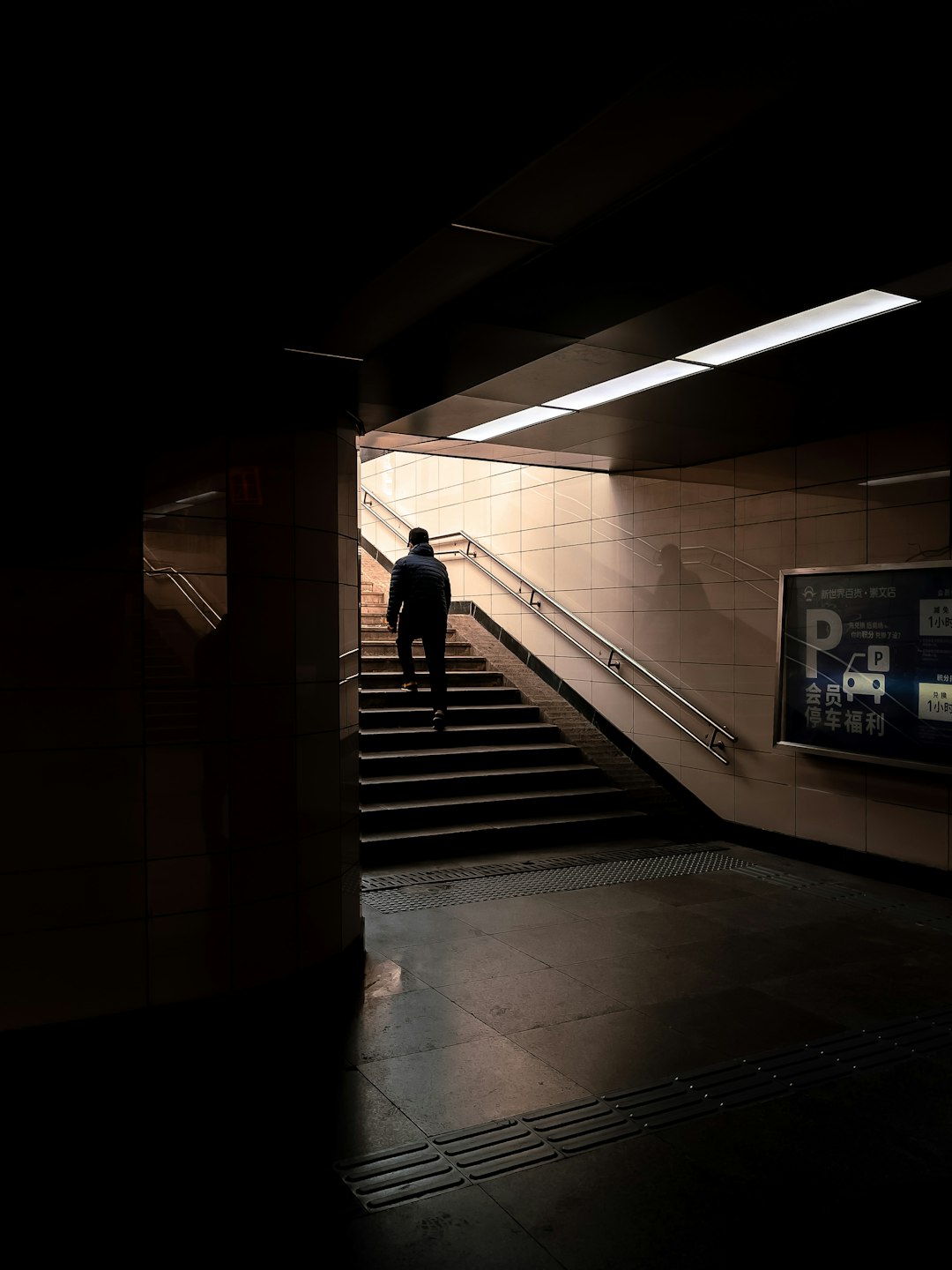 woman in black dress walking on hallway