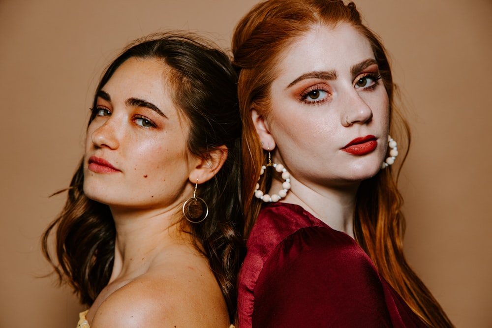 woman in red off shoulder shirt beside woman in red off shoulder top