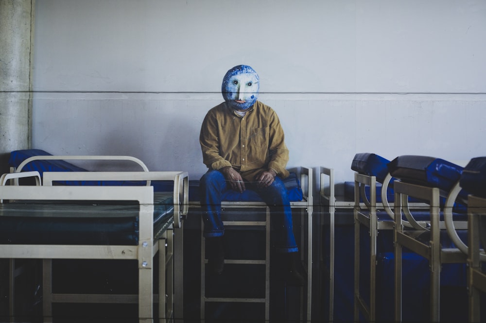 2 person in white helmet sitting on blue chair