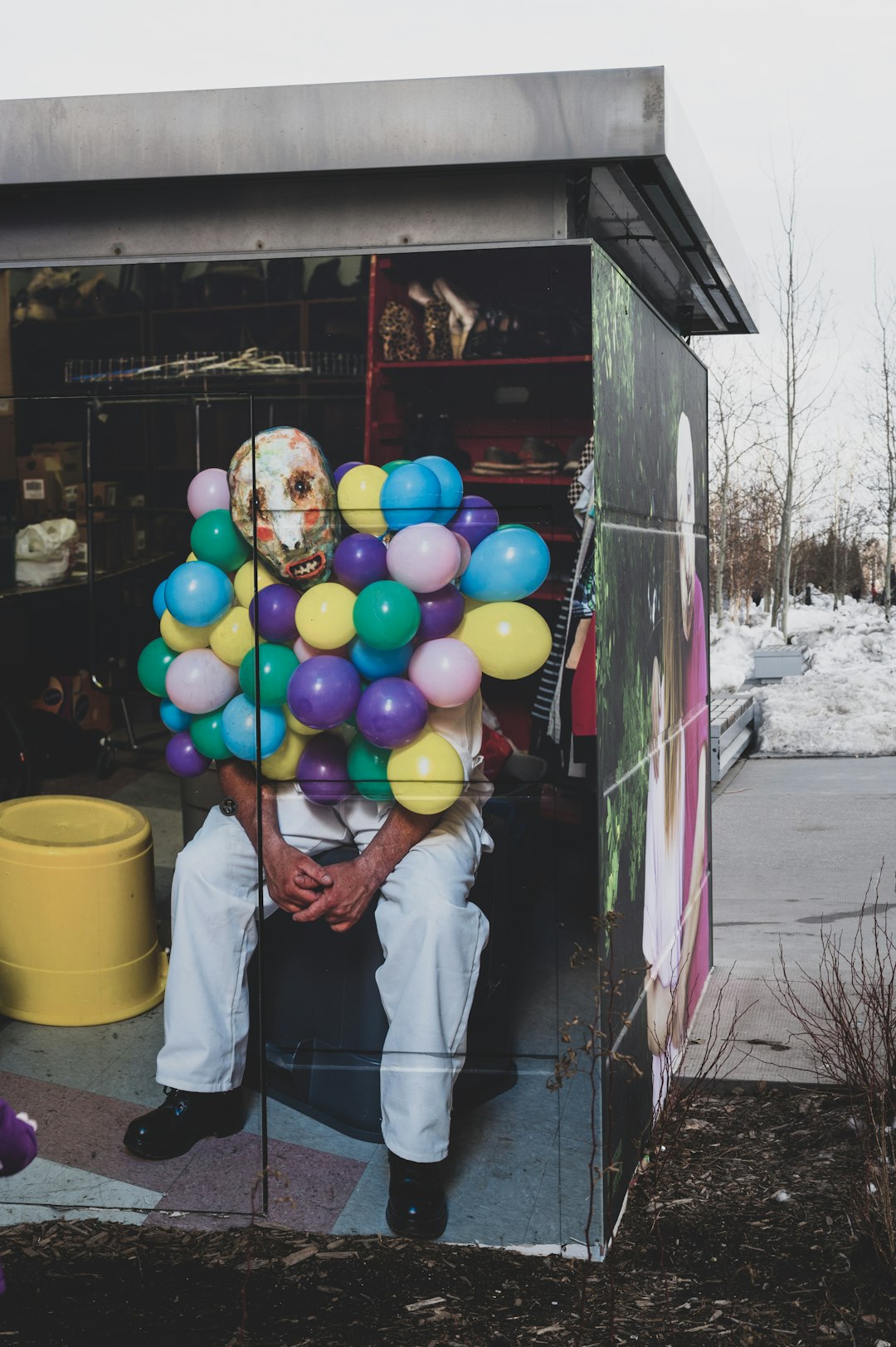 man in white t-shirt holding balloons