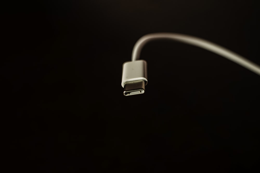 white usb cable on black surface