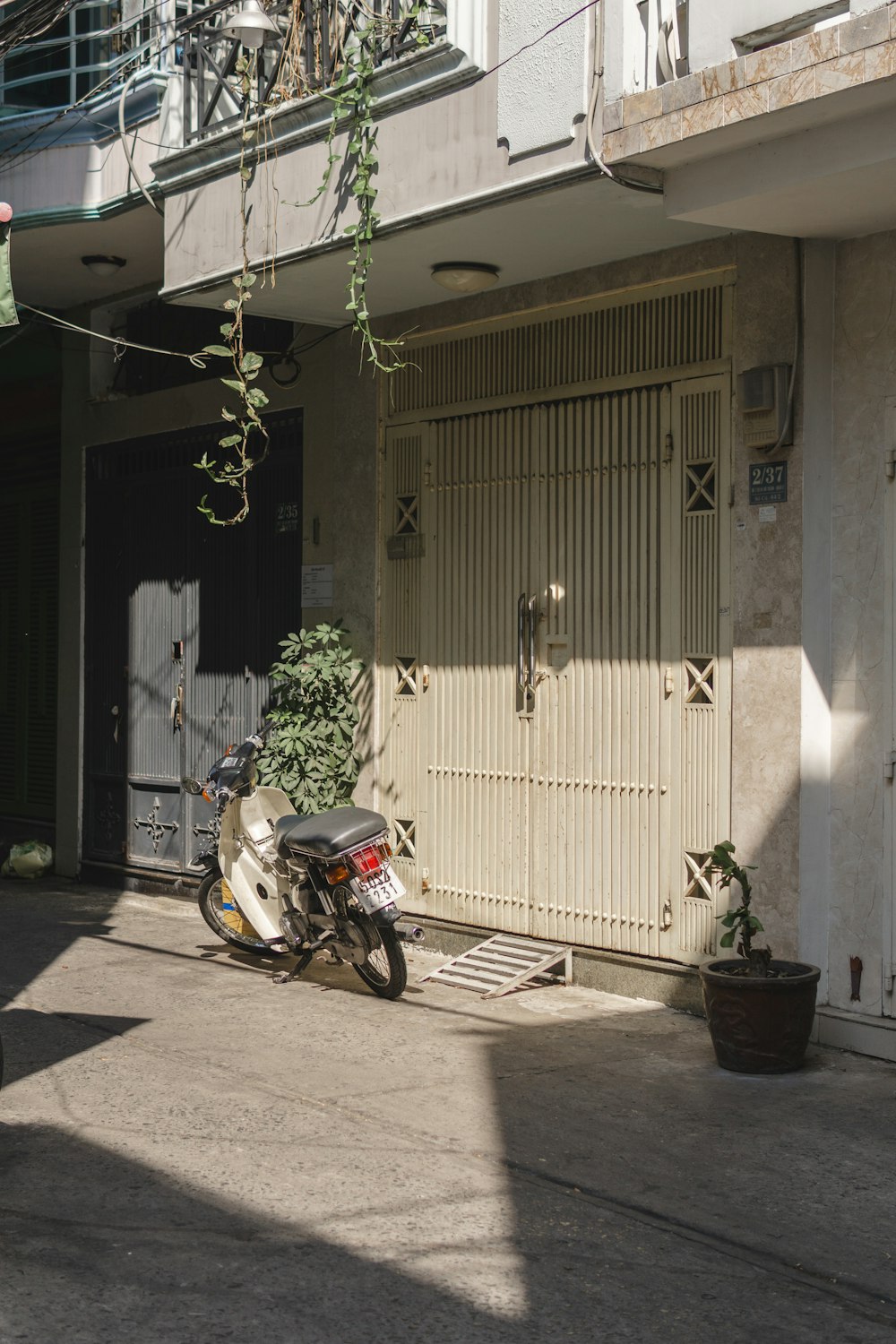 black and red motorcycle parked beside brown wooden door