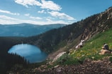 A serene landscape with a person writing in a notebook.
