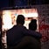 A happy couple enjoying fresh fish tacos at the food truck by the dock.