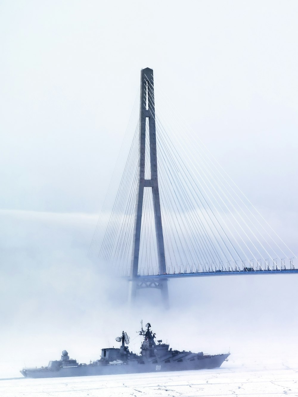 people walking on bridge during foggy weather